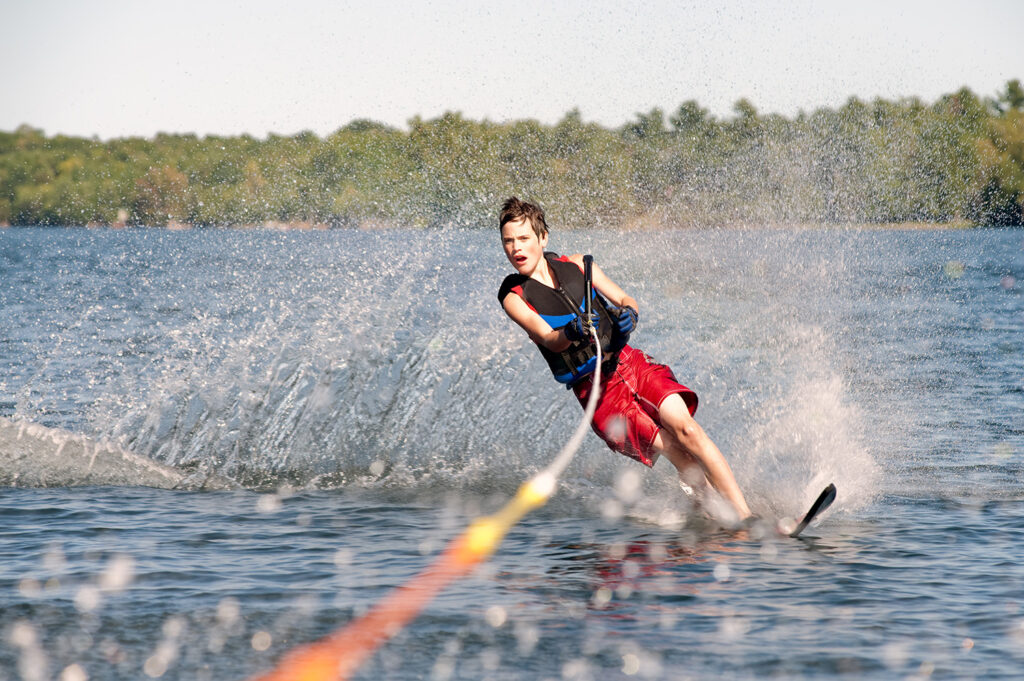 Teenage boy waterskiing on a lake